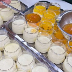 Hình ảnh panna cotta trái cây tại Sari Bakery với nhiều hũ bánh lạnh, topping trái cây nhiệt đới đa dạng, màu sắc bắt mắt.